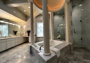 A modern bathroom with a large bathtub, a walk-in shower, and a vanity with a mirror. - Premium King Grand Suite Near Sacramento's Top Attractions (Sacramento)