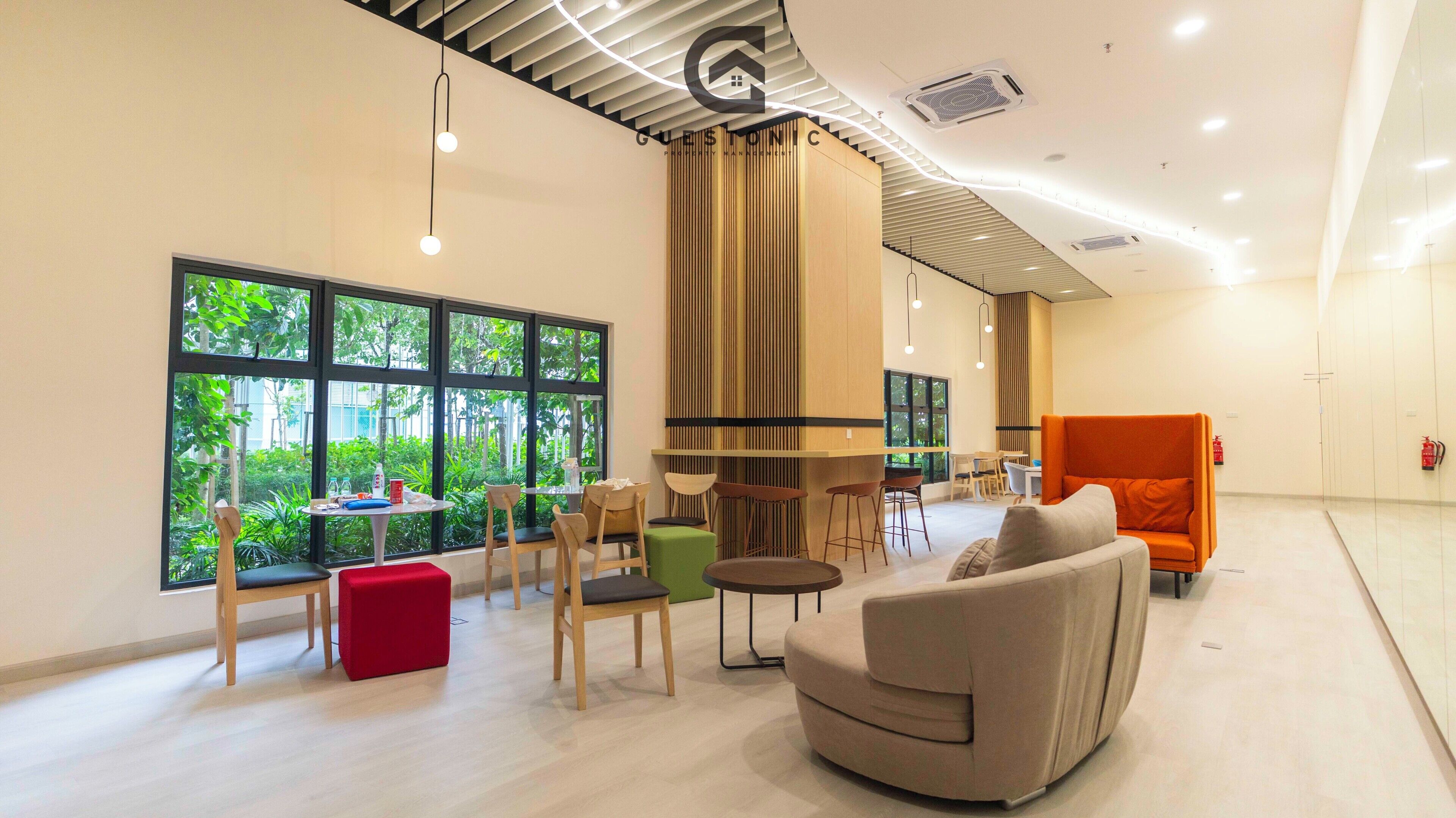 A modern interior with a seating area, large windows, and a curved ceiling design.
