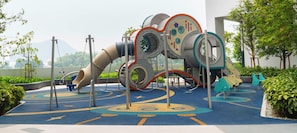 A playground with a slide, swings, and climbing structures. - Astrum Ampang by Guestonic (Kuala Lumpur)