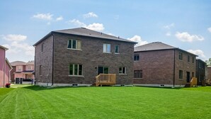 A multi-story building with a flat roof and brick exterior, surrounded by a well-maintained lawn.