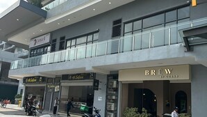 A multi-story building with a restaurant named 'Brew by Cobnb' on the ground floor. - Cozy 2-bedroom apartment near KLCC, TRX, Gleneagles Hospital (Kuala Lumpur)