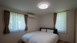 A bedroom with a bed, two windows with curtains, an air conditioning unit, and a ceiling light fixture. - Fuyu no Sonata 2 (Nakafurano)