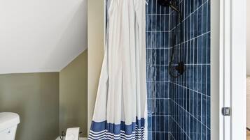 Shower, hair dryer, towels, toilet paper