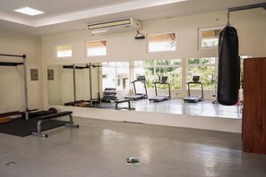 A gym with treadmills, a punching bag, and weightlifting equipment. - Cozy 2-bedroom apartment with AC in fantastic Limon (Limon)