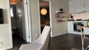 A modern apartment with a living room, kitchen, and a hallway leading to a bedroom. - 5 Star Holiday Home in Uddevalla (Uddevalla)