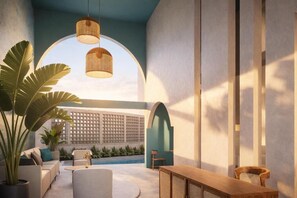 A modern interior with a seating area, a wooden table, and hanging lights. - SUWA CHANDU (Mirissa)
