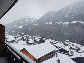 A snowy mountain village with traditional wooden houses and a view of snow-covered peaks. - Le Cocon, (Champery), by Interhome (Champery)