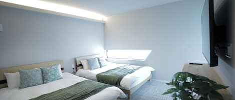 A modern hotel room with two beds, a large window, a flat-screen TV, and a potted plant.