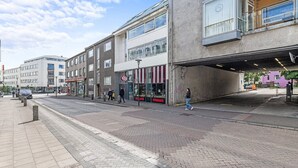 En gade med bygninger, et fodgængerfelt og en person, der går.