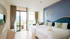 A hotel room with two beds, a TV, a balcony, and a view of the city.