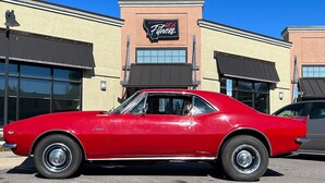 A red vintage car parked in front of a building with a sign that reads '406 Fitness.' - Perfect 3-bedroom house centrally located in the Flathead. (Kalispell)