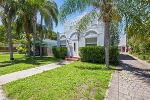 A building with a stone facade, arched windows, and a front entrance with steps. - West Palm Beach Home (West Palm Beach)