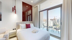 A hotel room with a large bed, a nightstand, a chair, a balcony with a view of the city. - Premium Studio l near Museum of Future and Metro (Al Satwa)