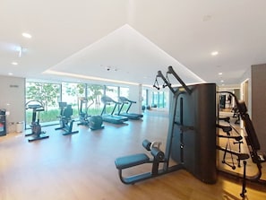 A gym with treadmills, elliptical machines, and weightlifting equipment. - Luxurious 1 Bed l City Walk Mall, Coca-Cola Arena (City Walk)