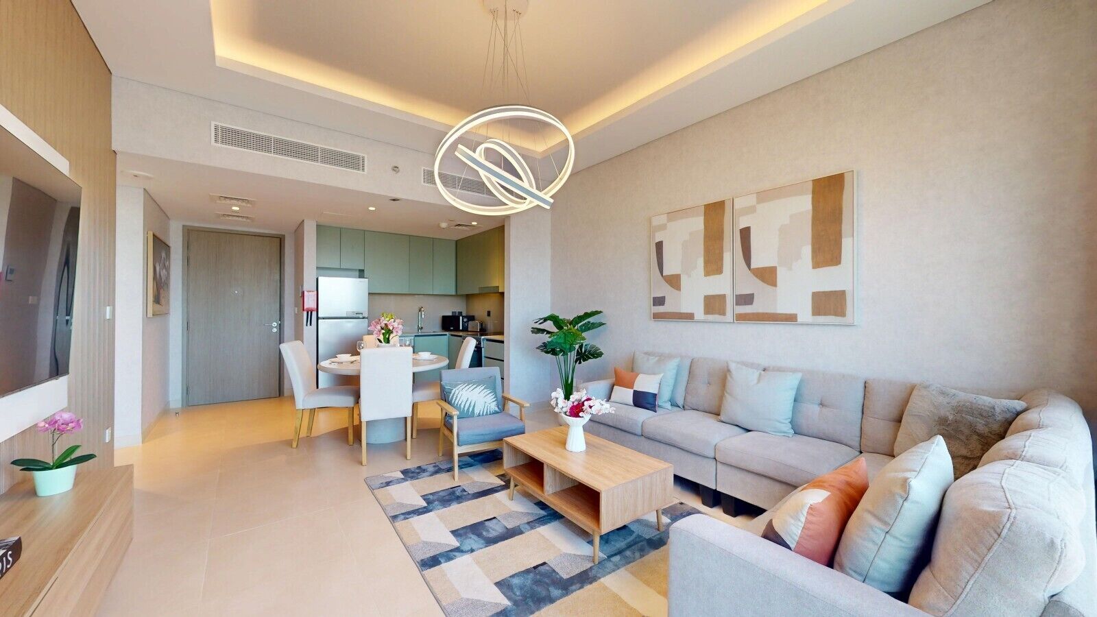 A modern living room with a sofa, coffee table, and dining area.