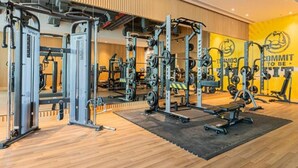 A gym with weightlifting equipment, mirrors, and a motivational wall. - Chic Studio in Palm l Pool & Gym (Palm Jumeirah)
