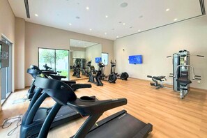 A gym with treadmills, elliptical machines, and weight equipment. - Sleek 3 Bed in Creek Harbour l Private Lagoon, Gym (Creek Harbour)