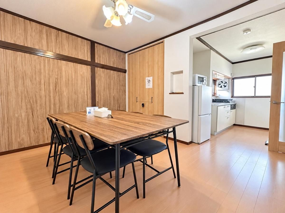 A modern kitchen with white cabinets, a microwave, and a refrigerator.