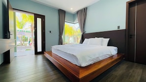 Un dormitorio con cama, baño y vistas al exterior.