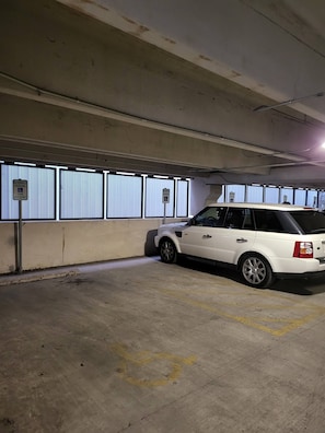 Eine Parkgarage mit einem weißen SUV, das in einem Stellplatz reserviert ist.