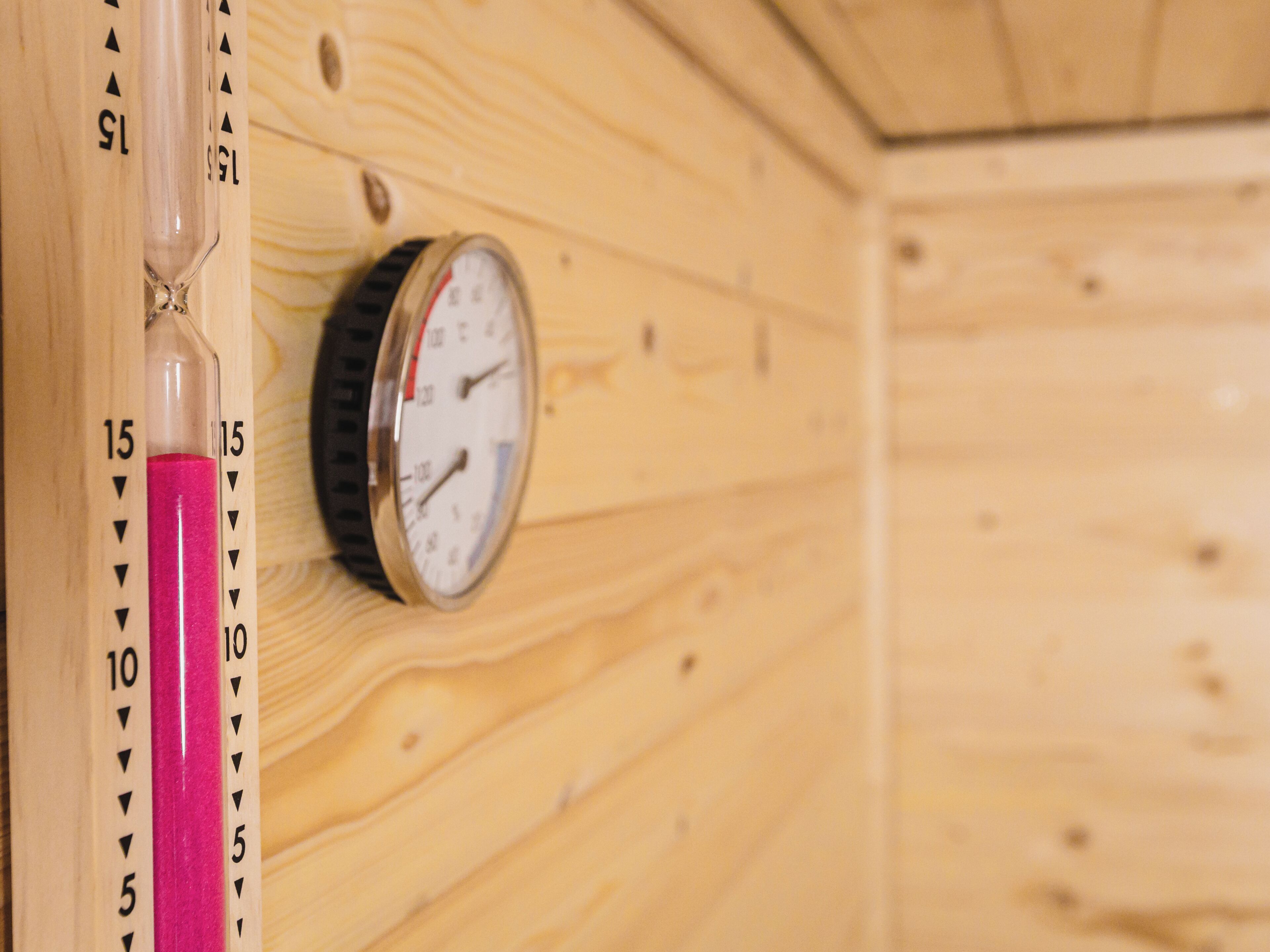A wooden wall with a pressure gauge and a vertical scale marked from 5 to 15.