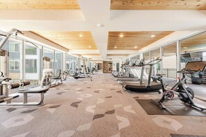 A gym with cardio machines, weight benches, and exercise equipment. - Riverwalk Downtown Luxury Pool & Free Parking (San Antonio)