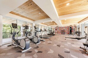 A gym with treadmills, elliptical machines, and weight equipment. - Riverwalk Downtown Luxury Pool & Free Parking (San Antonio)