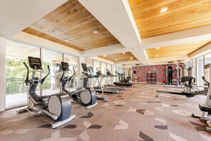 A gym with treadmills, stationary bikes, and weight machines.