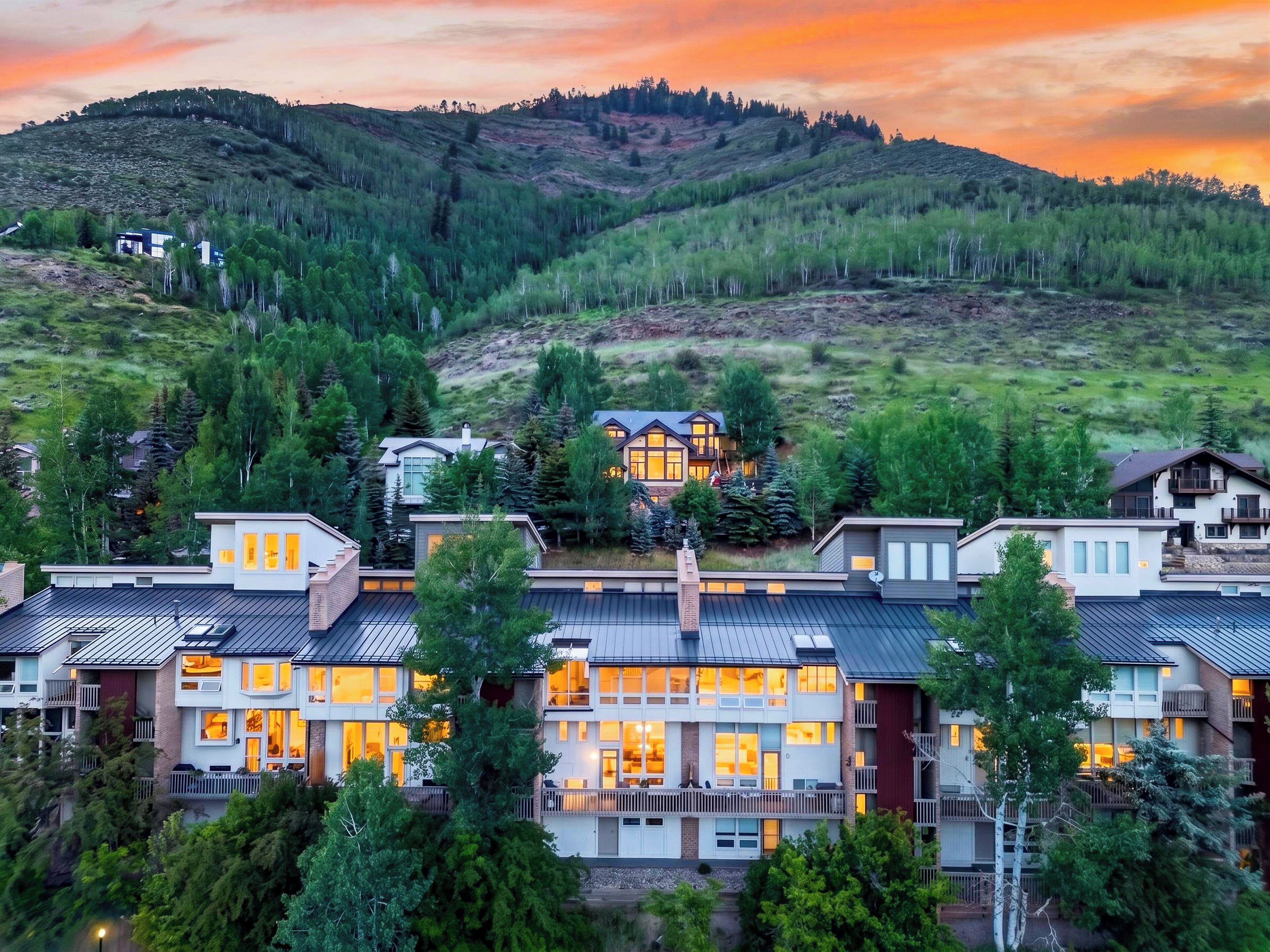 Gorgeous twilight exterior shot capturing the property as a peaceful mountain sanctuary nestled in nature.