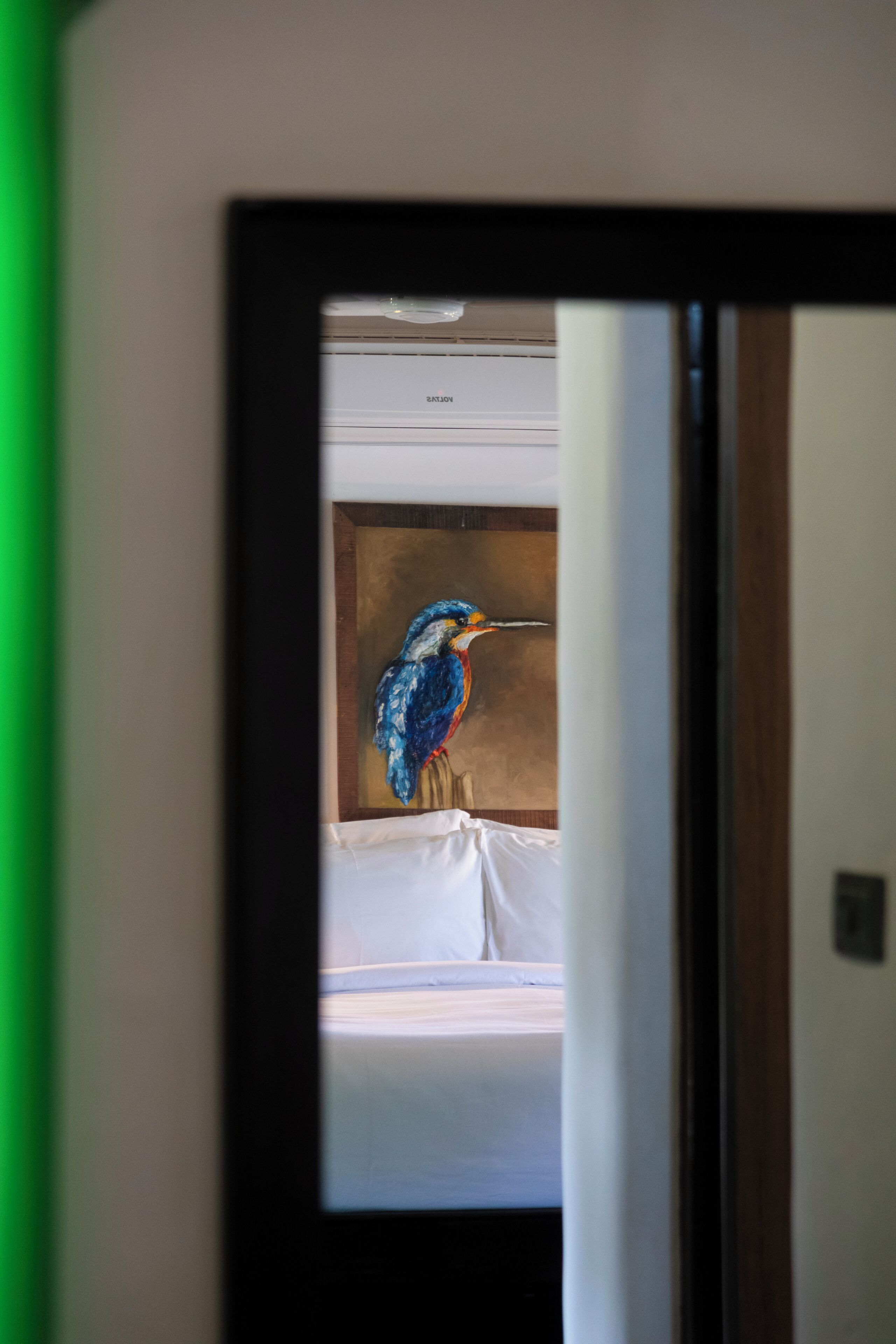 A painting of a bird on a wall.