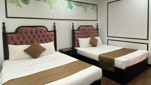 A hotel room with two beds, each with a headboard, white bedding, and brown accents. - King Luxury Hotel (Tu Liem)
