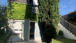 A house with a covered porch, a staircase, and a large evergreen tree. - The Sequoia... in the Countryside (Fondettes)