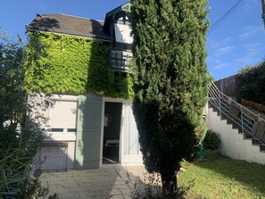 A house with a covered porch, a staircase, and a large evergreen tree. - The Sequoia... in the Countryside (Fondettes)