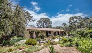 A house surrounded by a garden with various plants and trees. - Mi Casa - Monterey Home - Del Monte Golf Course Frontage (Monterey)