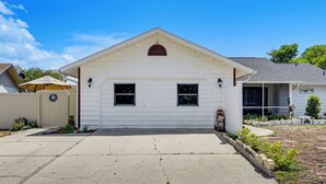 A single-story house with a front porch, a garage, and a small front yard. - 5 Mi to Beach! Couple’s Apt w/ Yard in Port Richey (Port Richey)
