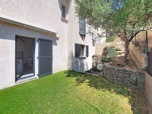A modern house with a well-maintained lawn, a stone wall, and a tree. - E Follicie by Interhome (Miomo)