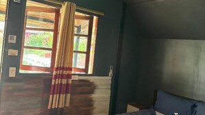 A room with a bed, a window with curtains, a ceiling light, and a wooden floor. - Grand Tree Resort (Ko Chang)
