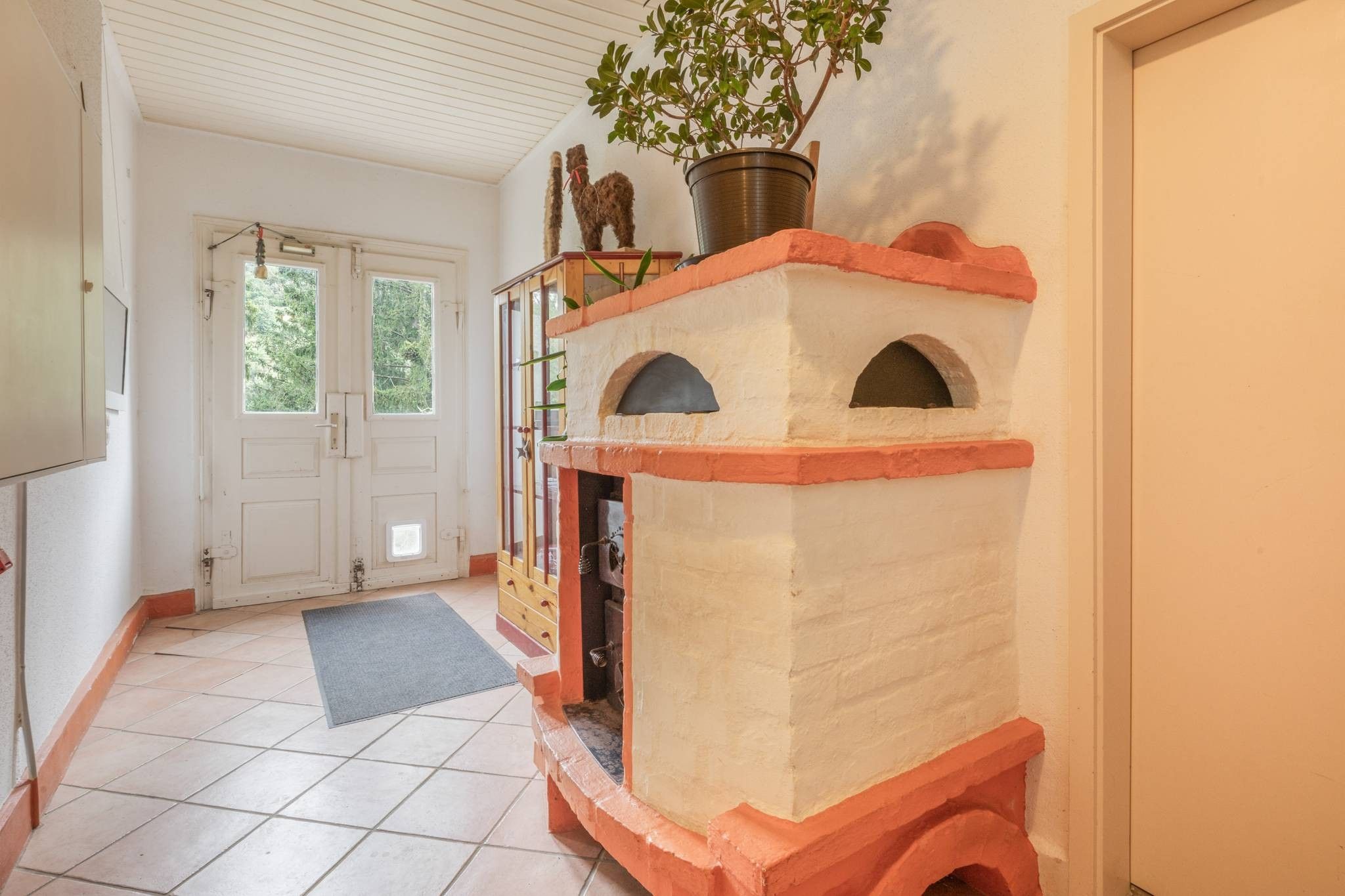 Una habitación con chimenea, una puerta y un ventanal.