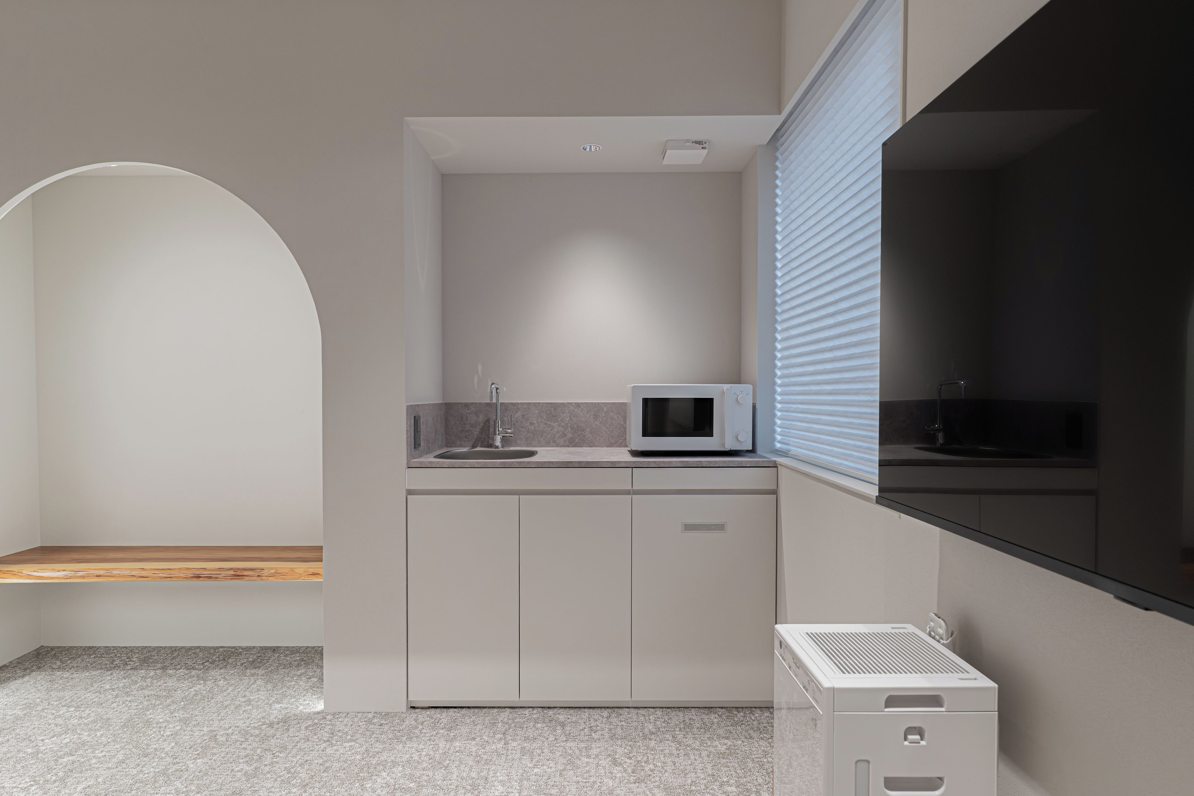 A modern kitchen with a microwave, sink, and built-in oven.