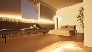 A modern bedroom with a sofa, a bed, a potted plant, and a large window. - Giraffe Nakasu haku (Fukuoka)