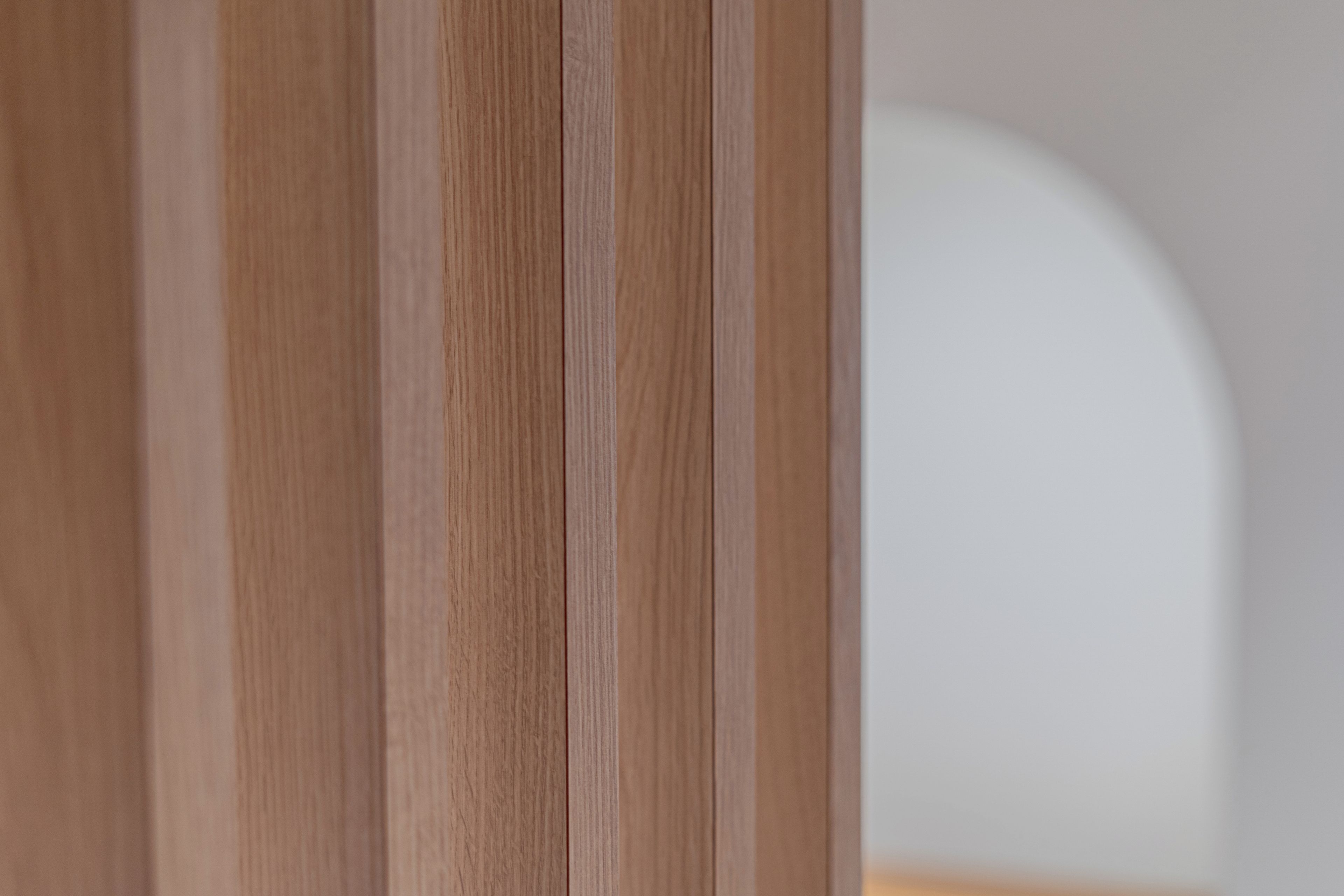 A close-up of a wooden door with vertical grain pattern.