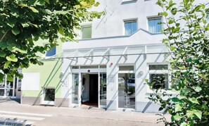 A modern building with a glass entrance, a visible door, and a small window. - Romantic Stuttgart Escape | Studio Double | Near Porsche Museum - 0.4 miles (Stuttgart)