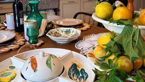 A dining table with plates, bowls, and a vase. - Arola Rustic Retreat (Arola-Preazzano)