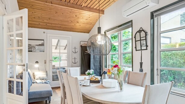 A modern dining area with a round table, chairs, and a pendant light. - "Unto" - 6km from the sea by Interhome (Esbjerg V)