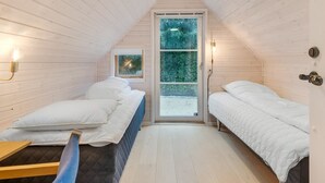 A small, cozy attic bedroom with two beds, a window, and a sloped ceiling. - "Unto" - 6km from the sea by Interhome (Esbjerg V)