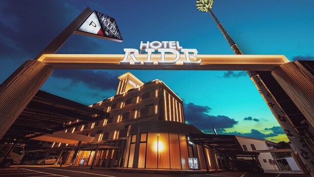 A hotel entrance with a prominent sign reading 'HOTEL RIDE' and a parking sign with a 'P' symbol.