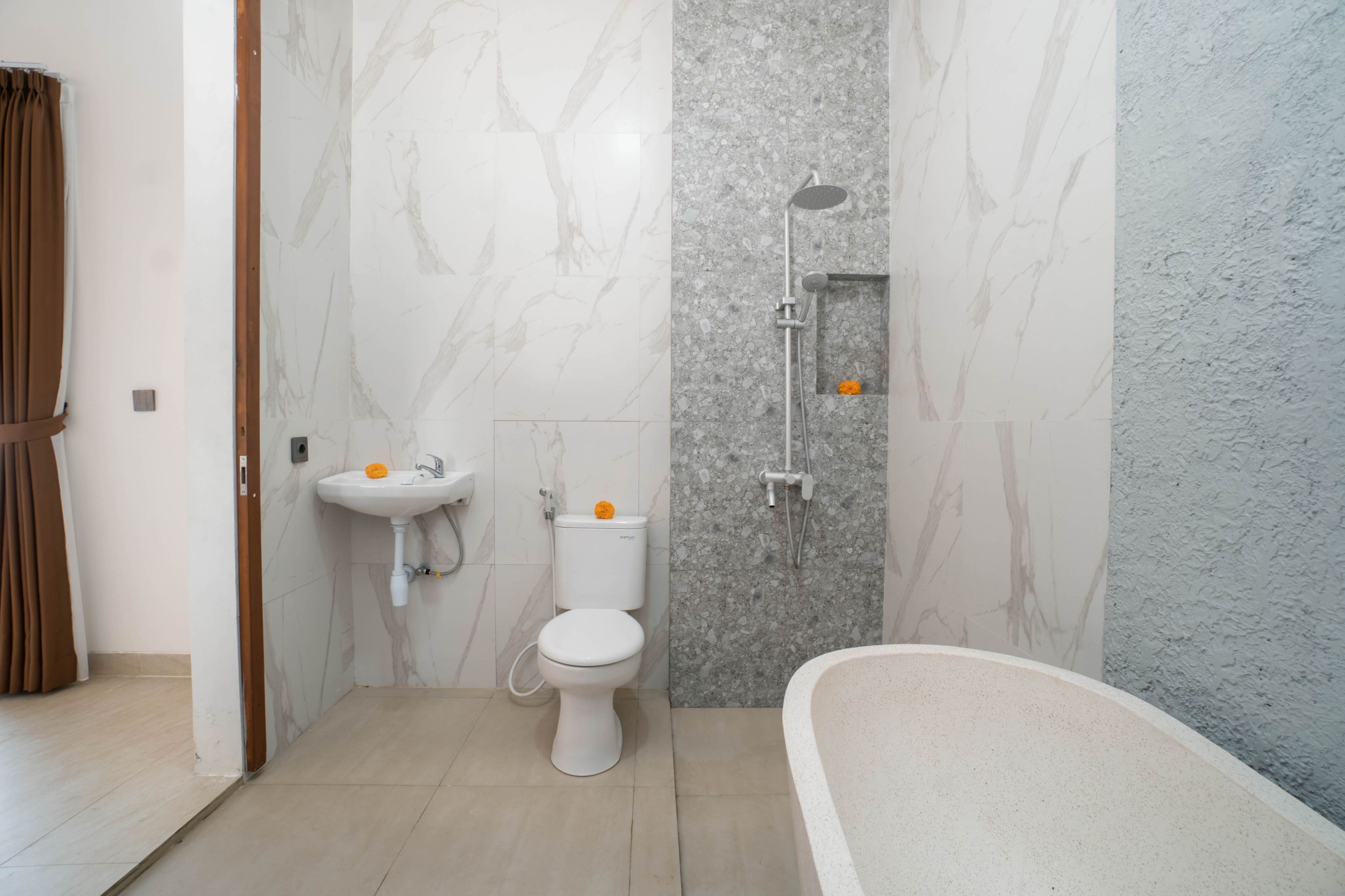 A bathroom with a toilet, sink, shower, and bathtub.