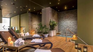 A spa area with massage chairs, candles, and a small pool. - Corporate Stays Unico - 1401 - 1Br (Asunción)