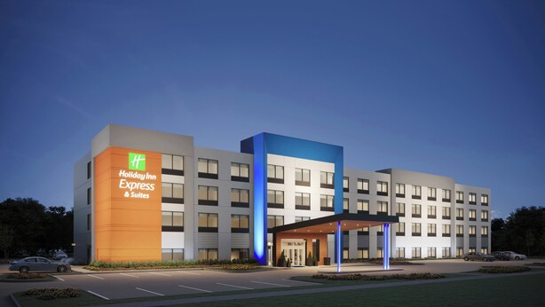 A Holiday Inn Express & Suites hotel with a modern design, featuring a prominent entrance and a parking lot. - Holiday Inn Express Knoxville Airport Alcoa by IHG (Alcoa)