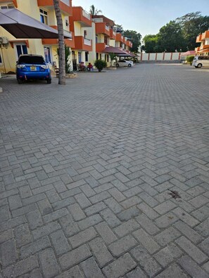 A paved outdoor area with buildings in the background. - Sun-Drenched Coastal Retreat in Vibrant Mombasa (Mombasa)